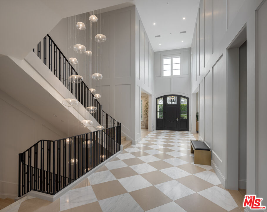 714 Alta Drive Beverly Hills, CA 90210 - Photo 7 of 29 a view of a hallway with wooden floor and windows