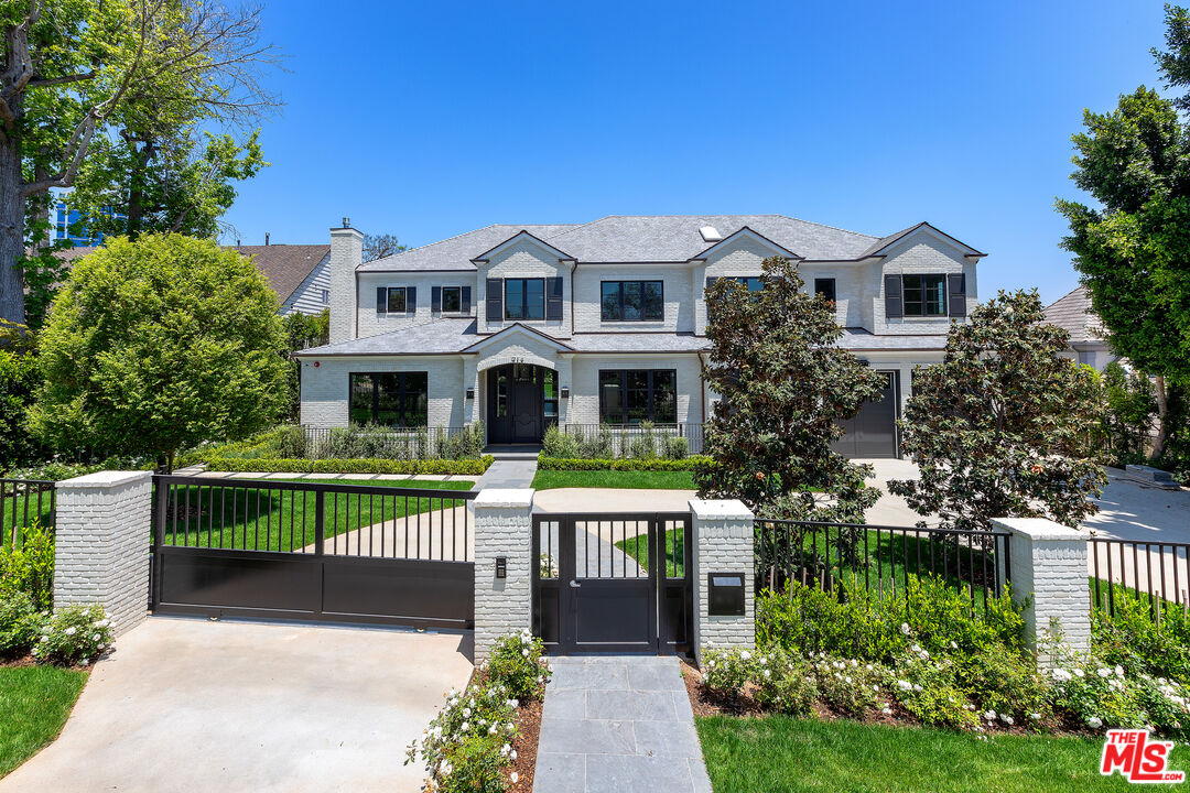 714 Alta Drive Beverly Hills, CA 90210 - Photo 9 of 29 a front view of a house with a garden