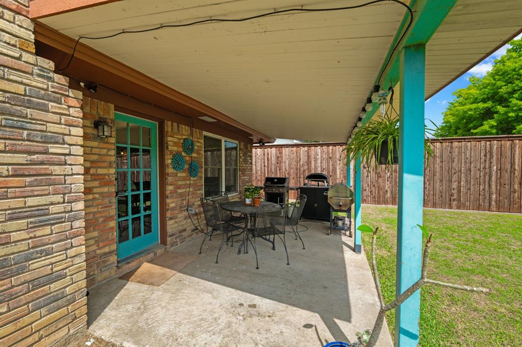 224 Overcrest Drive Benbrook, TX 76126 - Photo 35 of 39 a view of a patio with table and chairs with wooden floor and fence