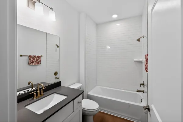 a bathroom with a sink toilet tub and shower