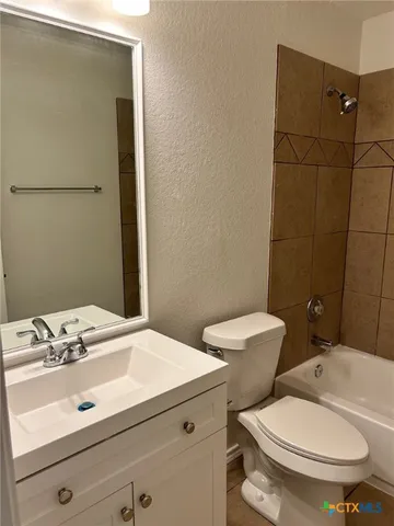 a bathroom with a sink a toilet and bathtub