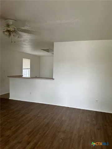 a kitchen with granite countertop a refrigerator and a sink