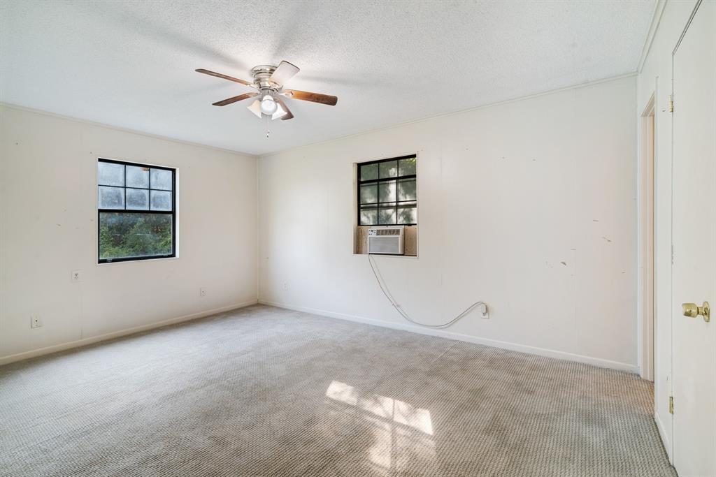 3875 Highway 271 Powderly, TX 75473 - Photo 15 of 25 an empty room with windows and fan