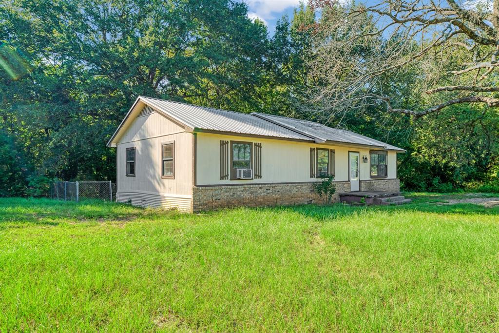 3875 Highway 271 Powderly, TX 75473 - Photo 3 of 25 a view of a house with a backyard