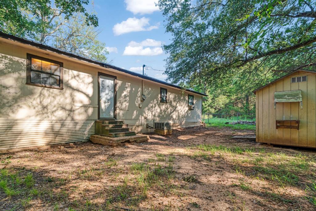 3875 Highway 271 Powderly, TX 75473 - Photo 5 of 25 a backyard of a house with barbeque oven