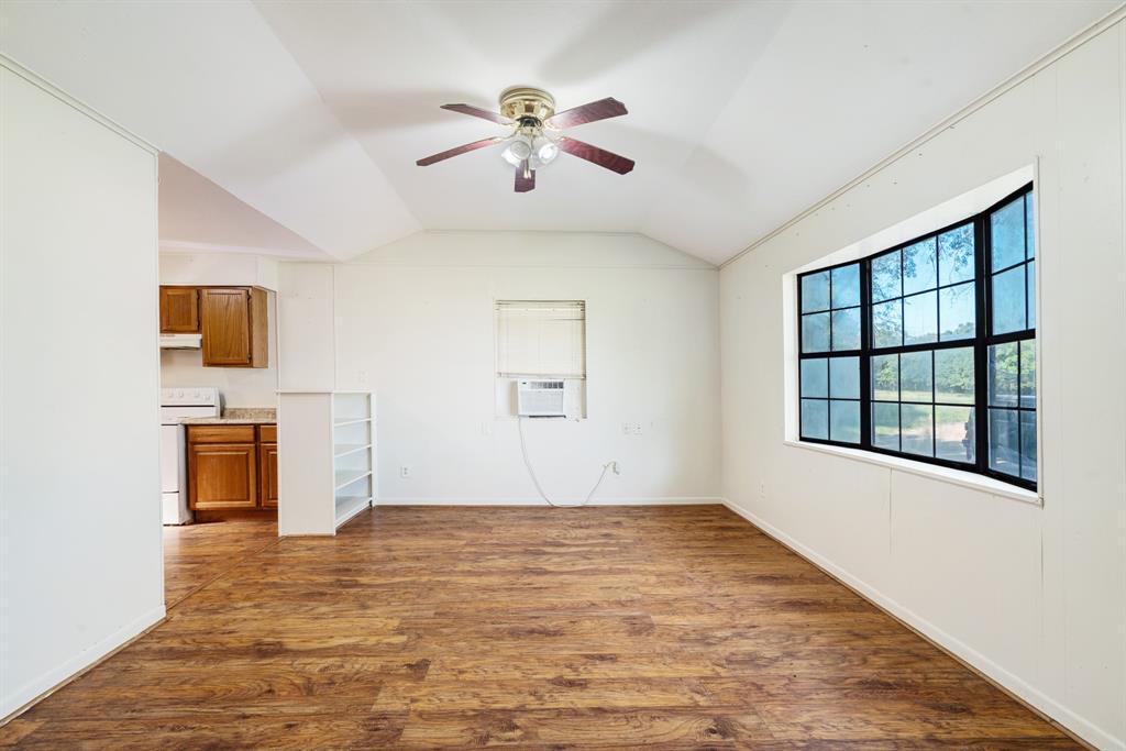 3875 Highway 271 Powderly, TX 75473 - Photo 6 of 25 wooden floor in an empty room with a window