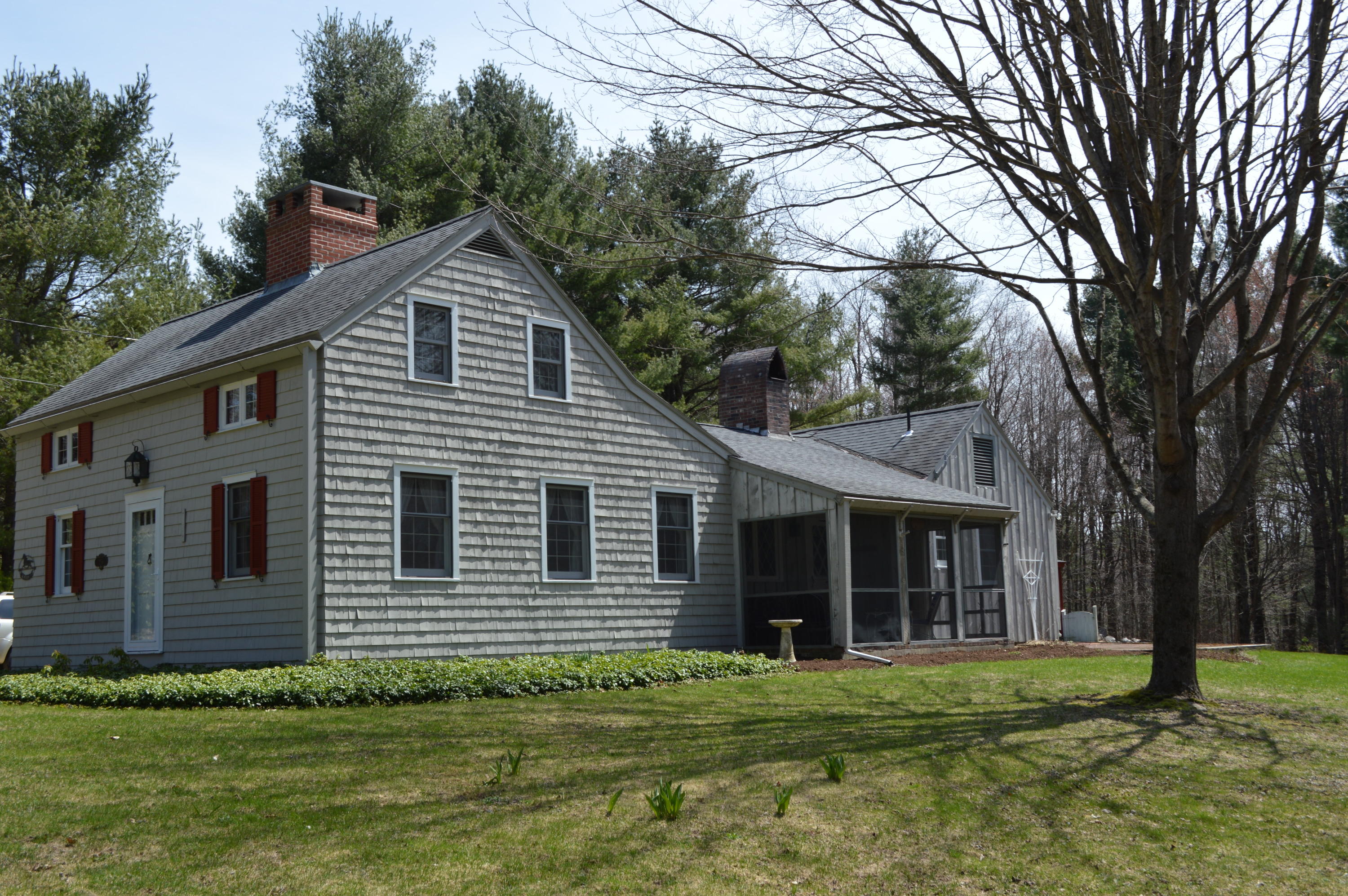 256 Middlefield Road Washington, MA 01223 - Photo 1 of 45 a front view of a house with a garden