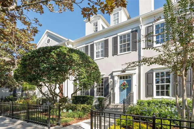 a front view of a building with a tree
