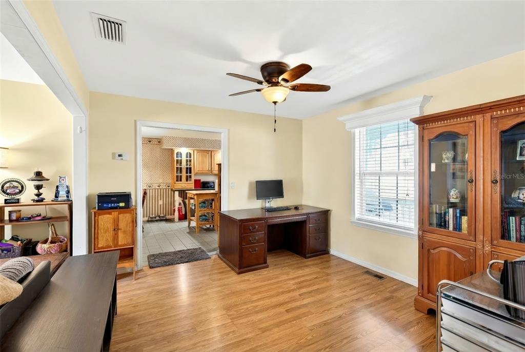 5940 Northeast 57th Loop Silver Springs, FL 34488 - Photo 14 of 44 a living room with furniture a flat screen tv and wooden floor