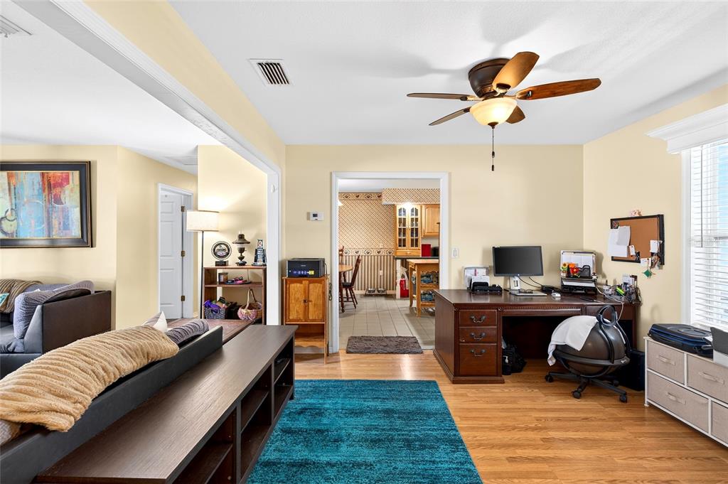 5940 Northeast 57th Loop Silver Springs, FL 34488 - Photo 17 of 44 a living room with furniture and a chandelier