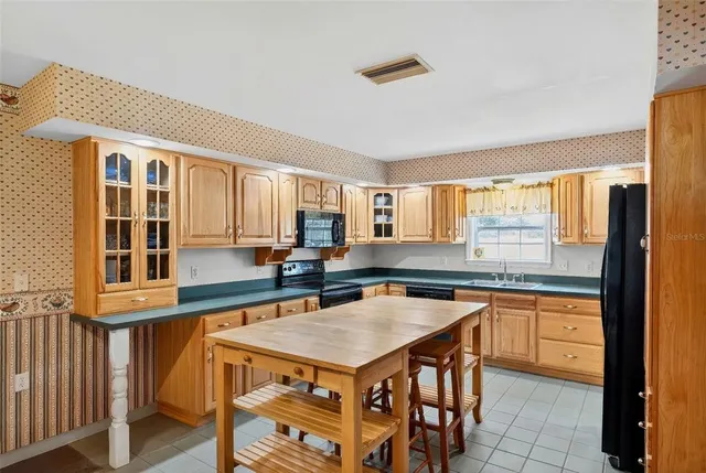 a kitchen with a stove a sink and a refrigerator