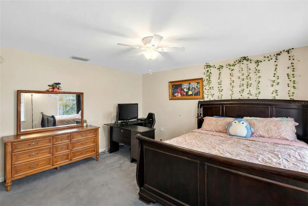 5940 Northeast 57th Loop Silver Springs, FL 34488 - Photo 25 of 44 a bedroom with a bed and a dresser