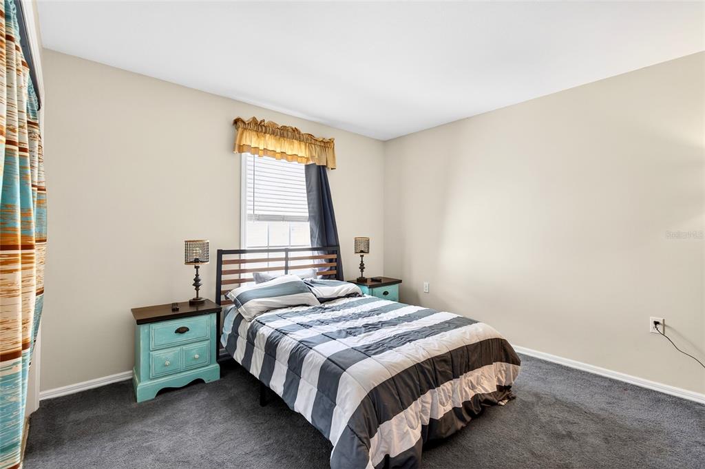 5940 Northeast 57th Loop Silver Springs, FL 34488 - Photo 27 of 44 a bedroom with a bed and a window