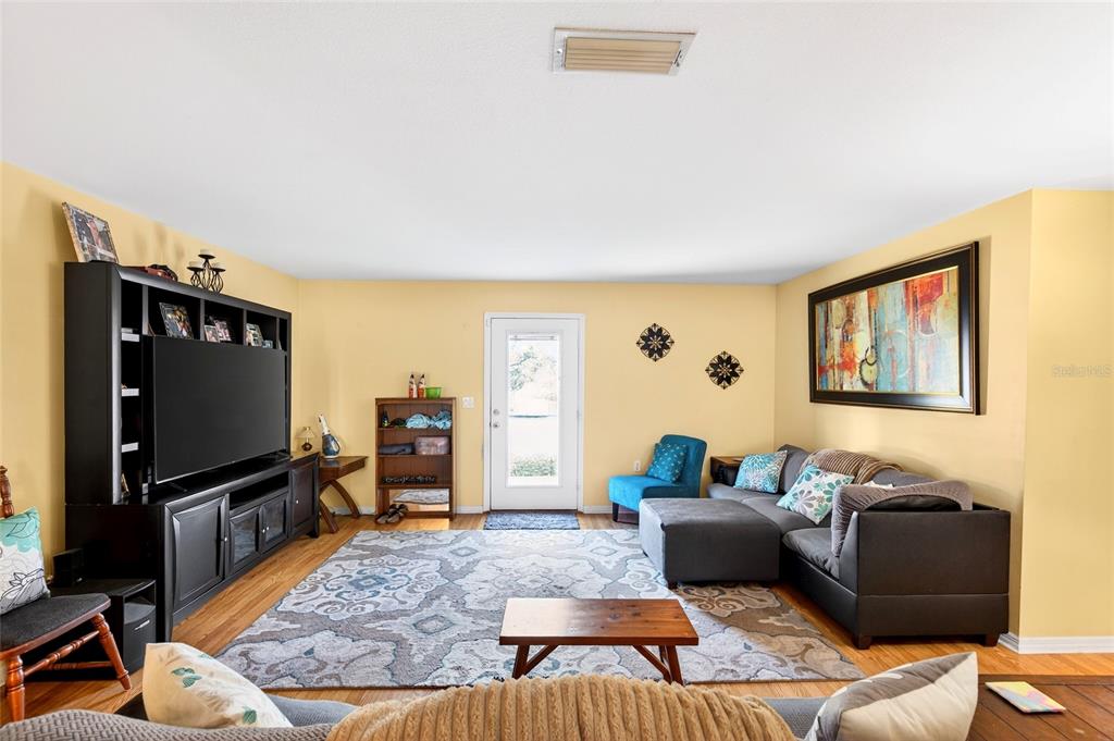 5940 Northeast 57th Loop Silver Springs, FL 34488 - Photo 32 of 44 a living room with furniture and a flat screen tv