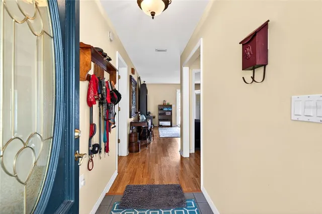 a view of a hallway with wooden floor and windows