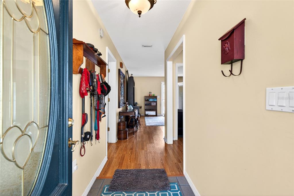5940 Northeast 57th Loop Silver Springs, FL 34488 - Photo 4 of 44 a view of a hallway with wooden floor and windows