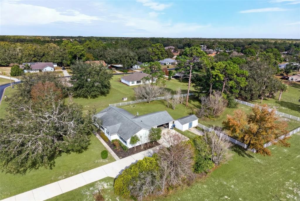5940 Northeast 57th Loop Silver Springs, FL 34488 - Photo 41 of 44 an aerial view of residential houses with outdoor space