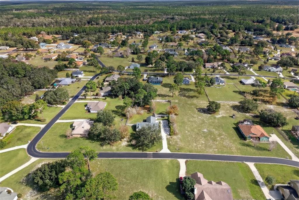 5940 Northeast 57th Loop Silver Springs, FL 34488 - Photo 44 of 44 an aerial view of residential houses with outdoor space and swimming pool