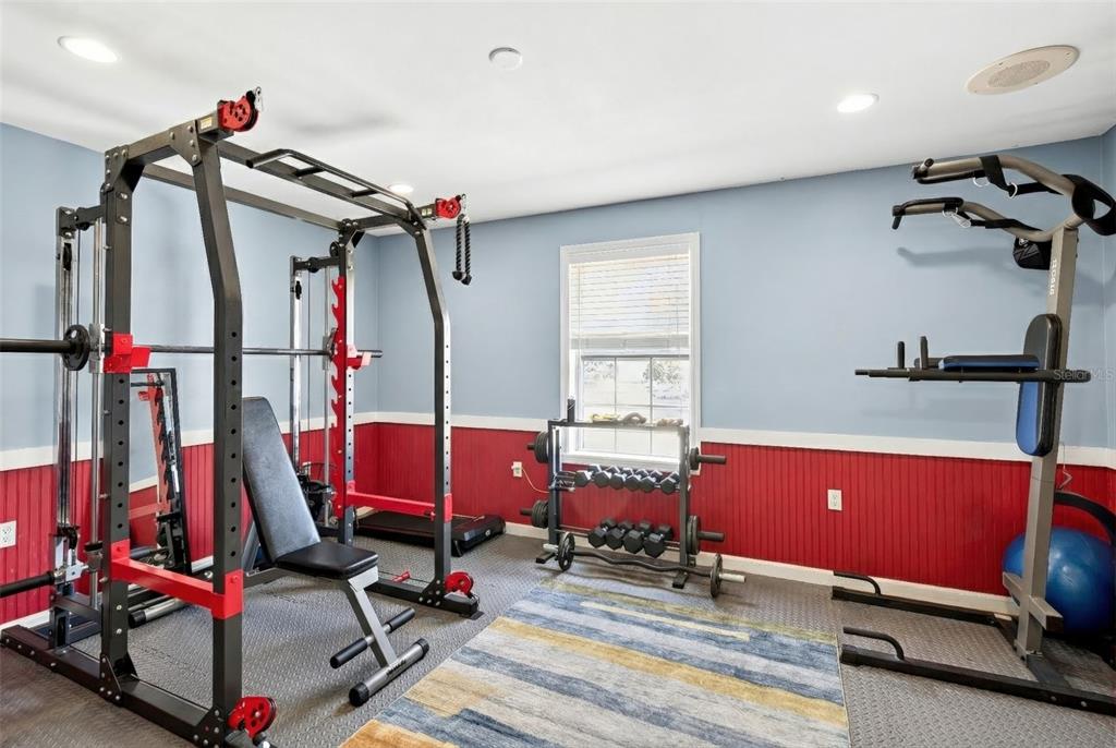 5940 Northeast 57th Loop Silver Springs, FL 34488 - Photo 10 of 44 a room with gym equipment and wooden floor