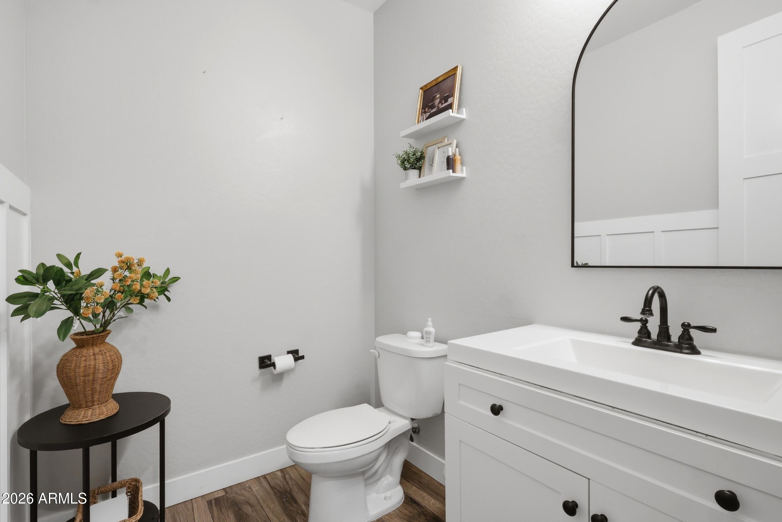 12517 West Lawrence Road Glendale, AZ 85307 - Photo 11 of 52 a bathroom with a toilet sink and mirror