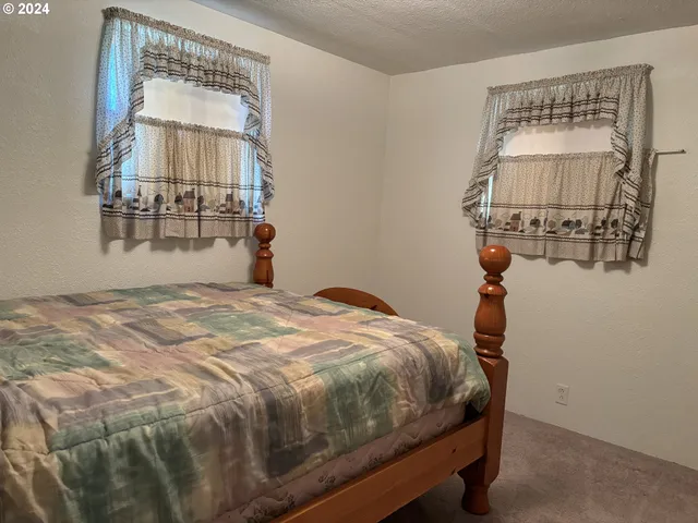 a bedroom with a bed and a mirror