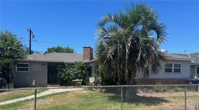 a house with palm tree in front of it