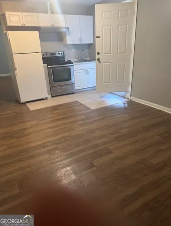 a kitchen with stainless steel appliances a refrigerator and a stove top oven