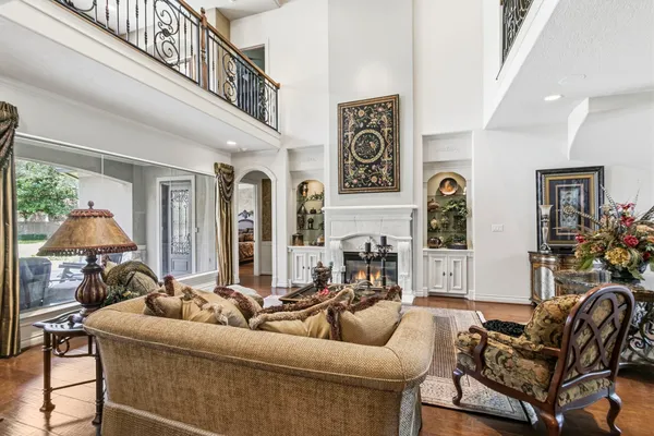 a living room with furniture and a chandelier