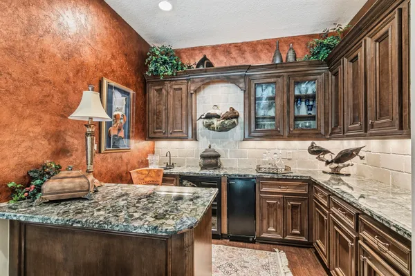 a view of a dining room with furniture a chandelier and wooden floor