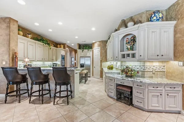 a kitchen with granite countertop a sink and a stove