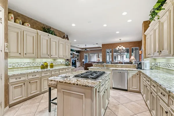 a kitchen with stainless steel appliances granite countertop a stove and cabinets