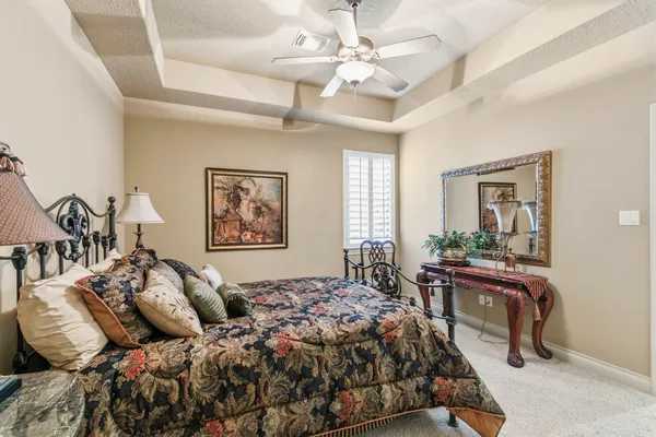 a en suite bathroom with a granite countertop sink and a mirror