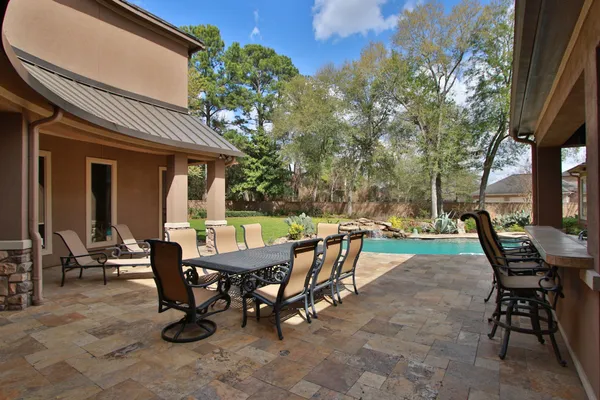 a view of a patio with chairs and potted plants
