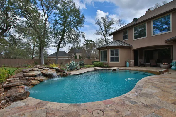 a view of a house with swimming pool and sitting area