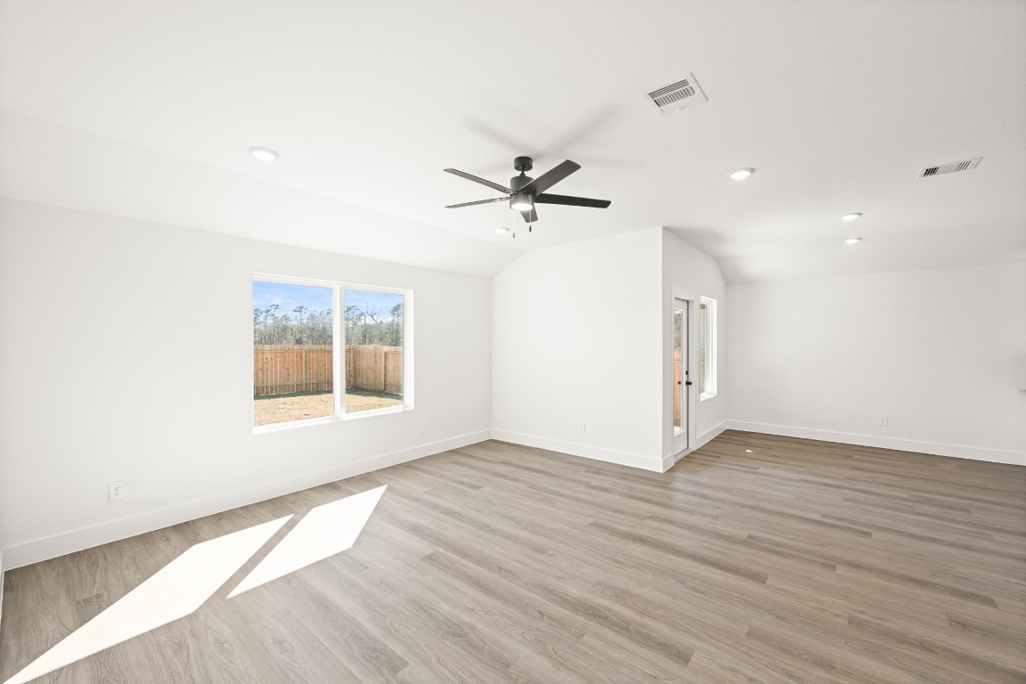 15775 Hanson Ridge Drive Montgomery, TX 77316 - Photo 11 of 33 an empty room with wooden floor and ceiling fan