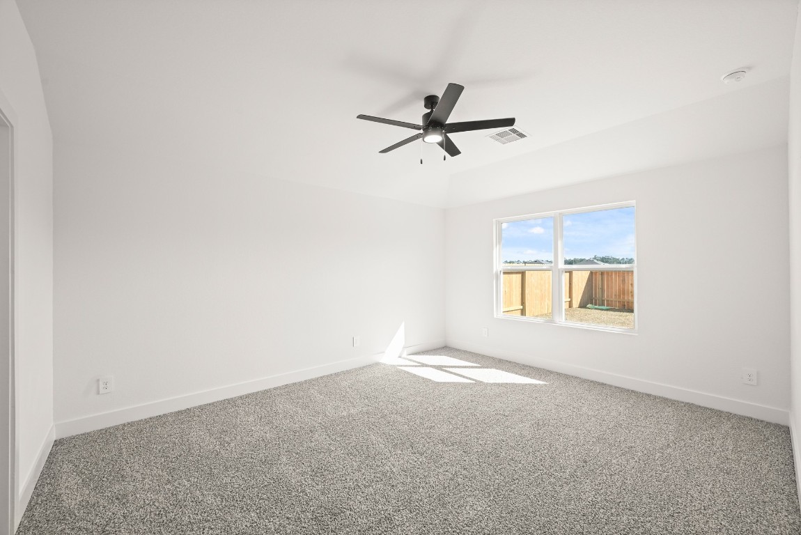 15775 Hanson Ridge Drive Montgomery, TX 77316 - Photo 12 of 33 an empty room with a window and a ceiling fan