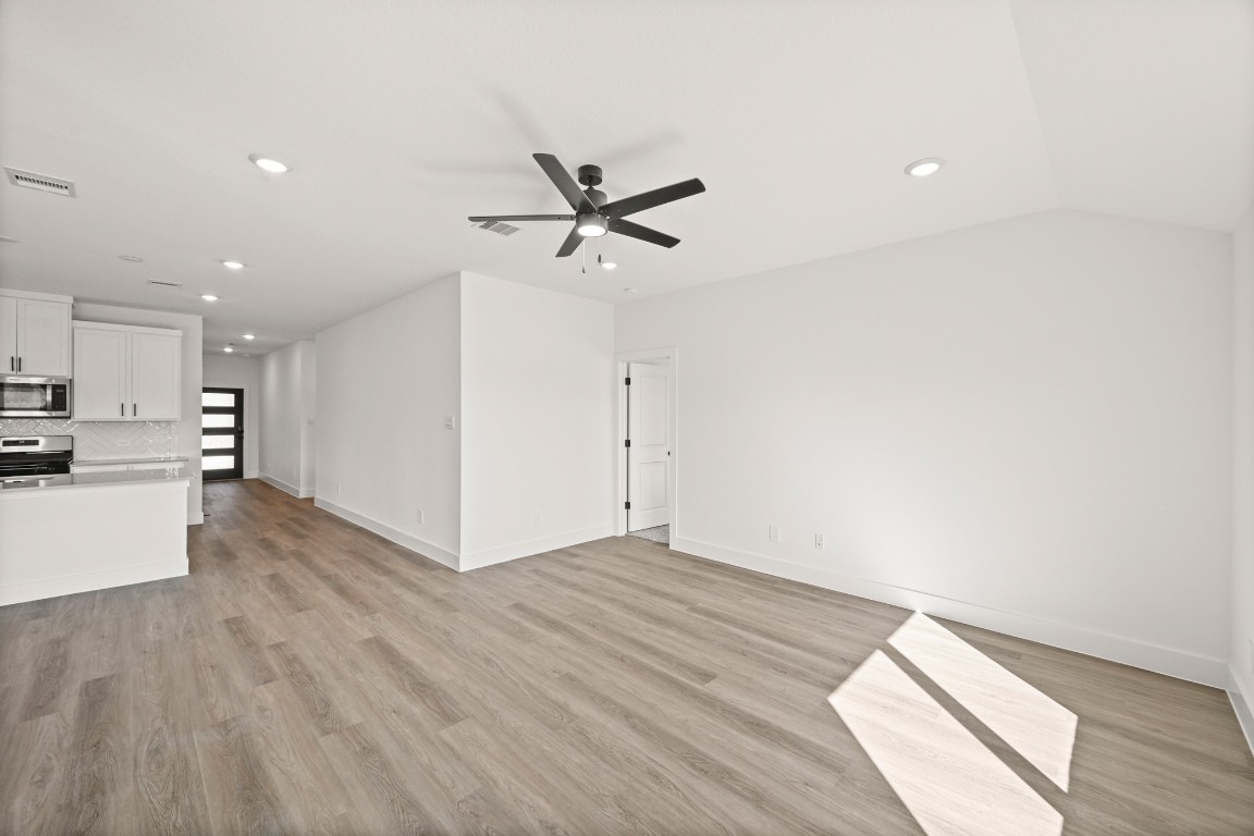 15775 Hanson Ridge Drive Montgomery, TX 77316 - Photo 8 of 33 a view of a kitchen with a dishwasher and wooden floor