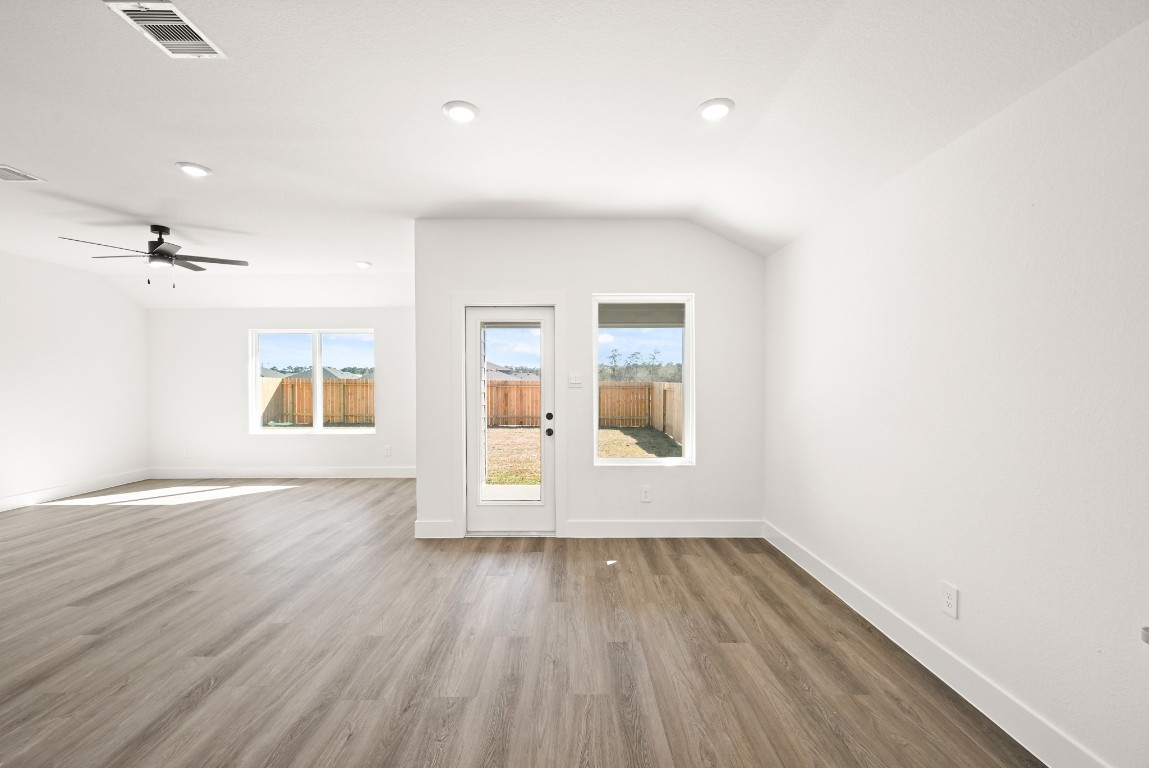15775 Hanson Ridge Drive Montgomery, TX 77316 - Photo 10 of 33 an empty room with wooden floor and windows