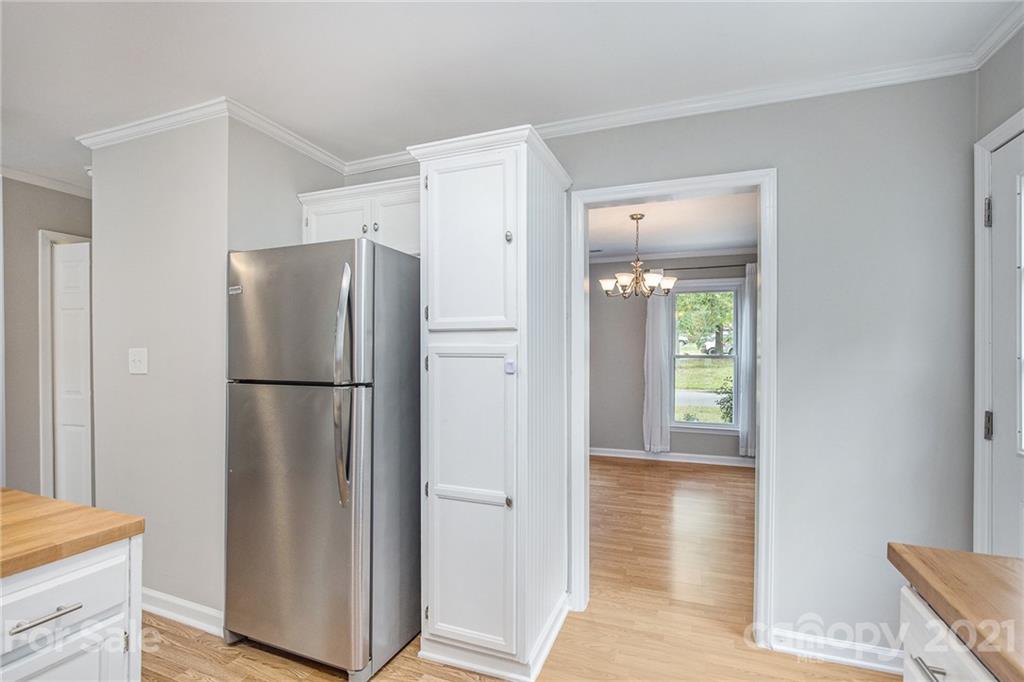 3517 Rosedown Drive Matthews, NC 28105 - Photo 11 of 28 a view of a kitchen with a refrigerator and a table