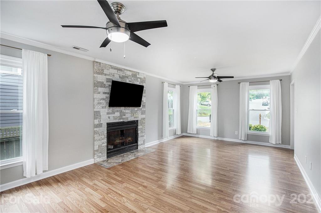 3517 Rosedown Drive Matthews, NC 28105 - Photo 15 of 28 an empty room with windows fireplace and cabinet