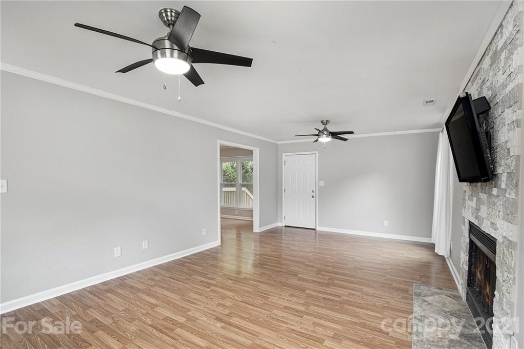 3517 Rosedown Drive Matthews, NC 28105 - Photo 17 of 28 wooden floor in an empty room with a chandelier fan