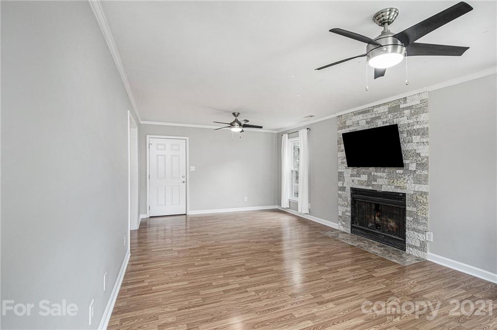 3517 Rosedown Drive Matthews, NC 28105 - Photo 18 of 28 a view of an empty room with a fireplace and a flat screen tv