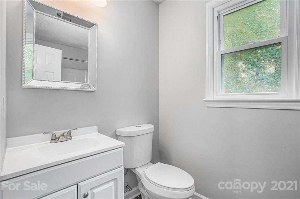 3517 Rosedown Drive Matthews, NC 28105 - Photo 19 of 28 a white toilet sitting next to a bathroom sink