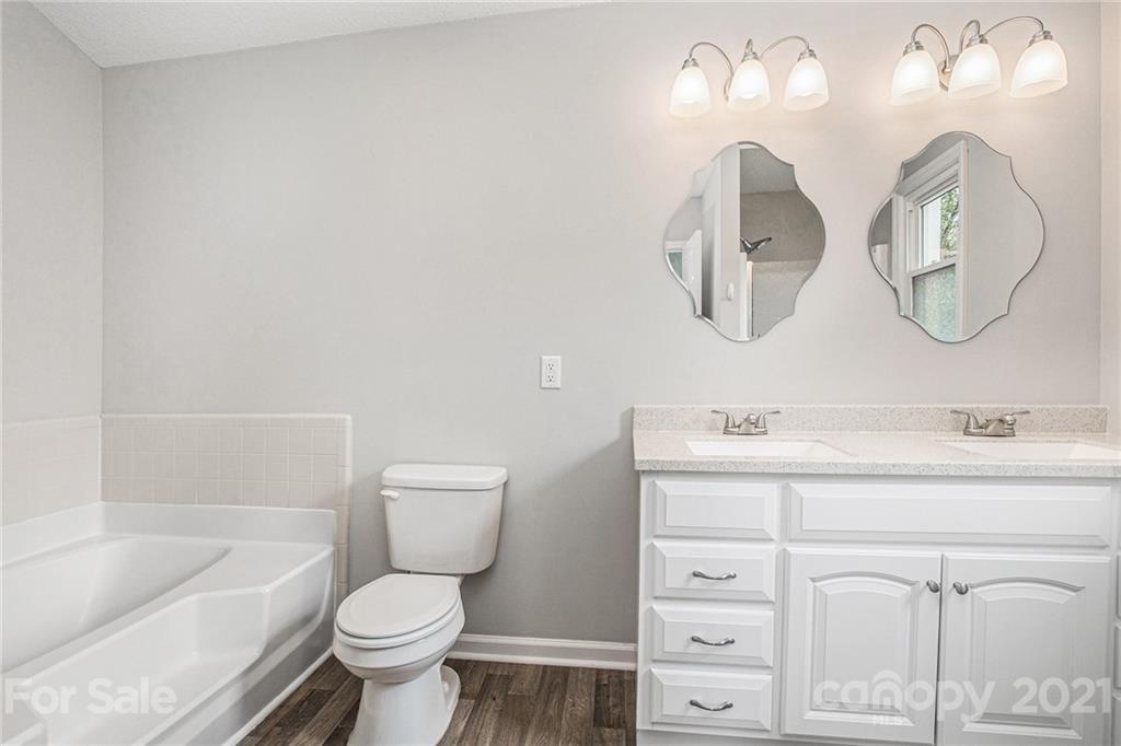 3517 Rosedown Drive Matthews, NC 28105 - Photo 23 of 28 a bathroom with a double vanity sink and a toilet