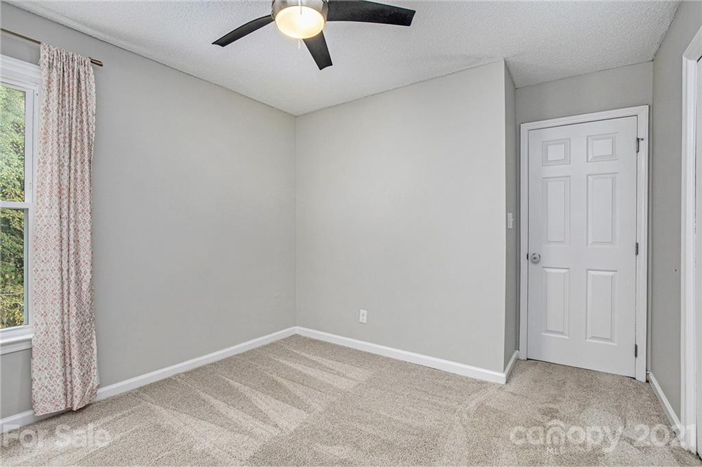 3517 Rosedown Drive Matthews, NC 28105 - Photo 26 of 28 an empty room with a ceiling fan and window