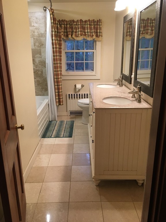 3333 Diamond Hill Road Cumberland, RI 02864 - Photo 17 of 29 a bathroom with a sink a mirror and a shower