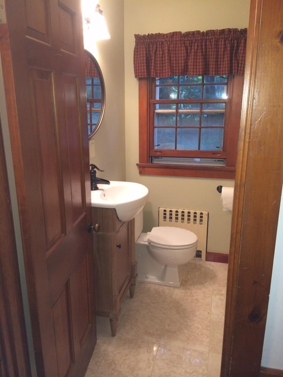 3333 Diamond Hill Road Cumberland, RI 02864 - Photo 19 of 29 a bathroom with a toilet a sink and a mirror