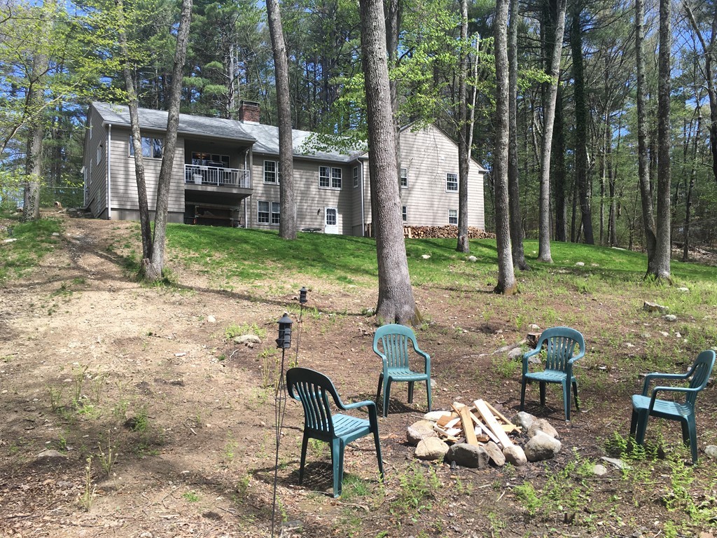 3333 Diamond Hill Road Cumberland, RI 02864 - Photo 3 of 29 a view of a backyard with table and chairs potted plants and large tree