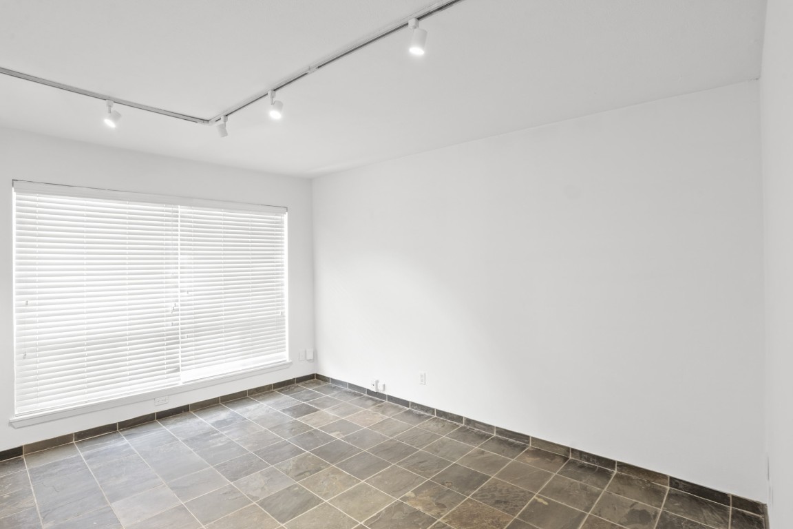 3602 Garrott Street, Unit 7 Houston, TX 77006 - Photo 13 of 34 The living space has a large window for lots of natural light. Track lighting and slate floors complete the space.
