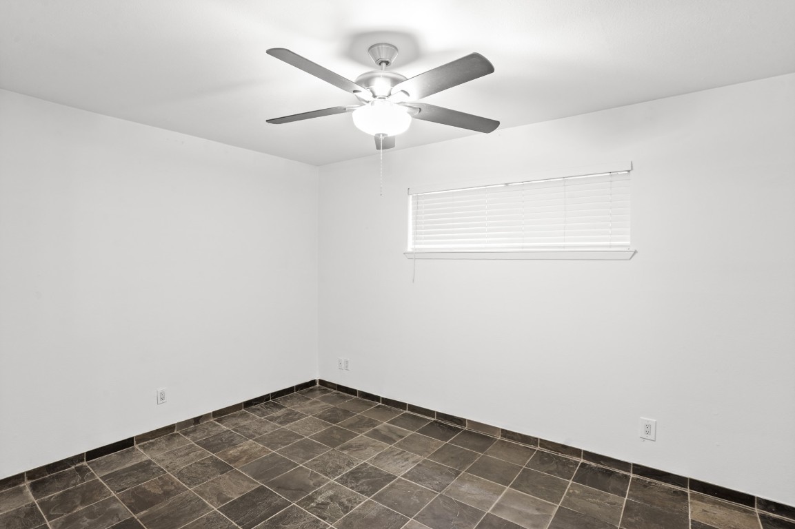 3602 Garrott Street, Unit 7 Houston, TX 77006 - Photo 20 of 34 The bedroom has a ceiling fan, window for more natural light and slate floors.